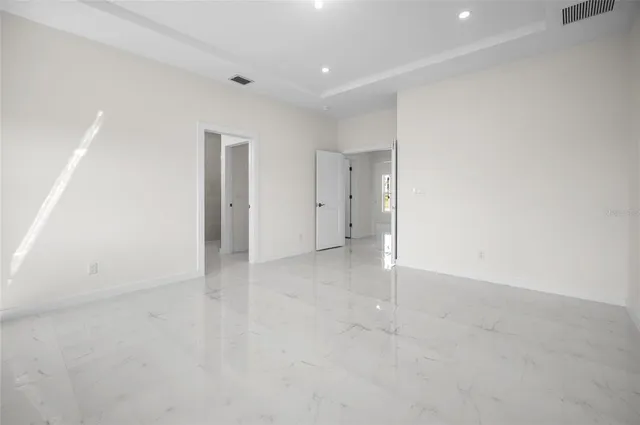 a bathroom with a granite countertop toilet a sink and shower