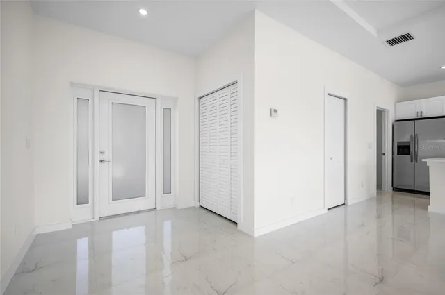 a view of a livingroom with kitchen space and a window