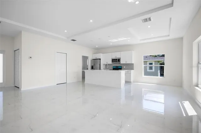a view of kitchen with furniture and refrigerator