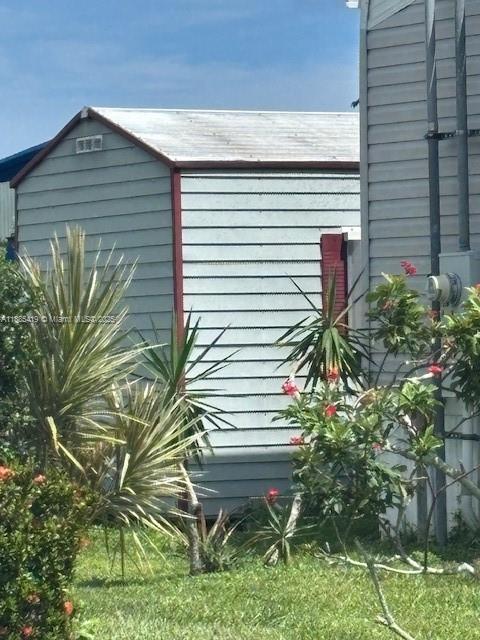 4087 Marigold Road Boynton Beach, FL 33436 - Photo 5 of 7 a plant that is sitting in front of a house