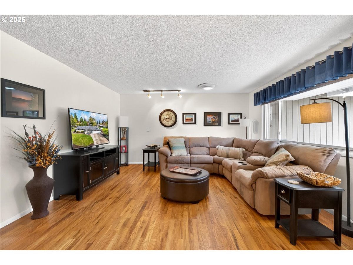 19650 Southwest Jaylee Street Beaverton, OR 97078 - Photo 14 of 46 a living room with furniture and a flat screen tv