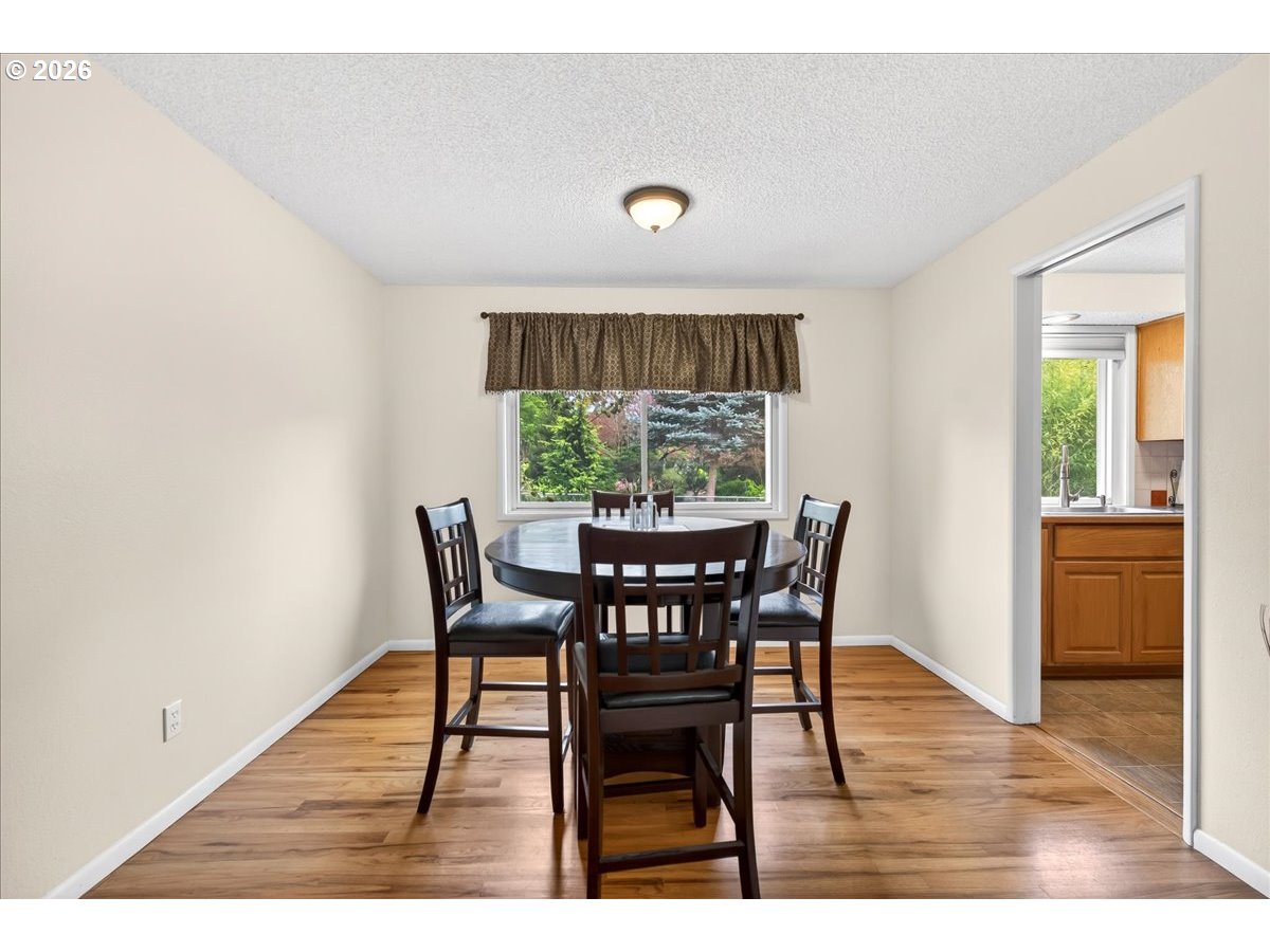 19650 Southwest Jaylee Street Beaverton, OR 97078 - Photo 18 of 46 a view of a dining room with furniture window and wooden floor
