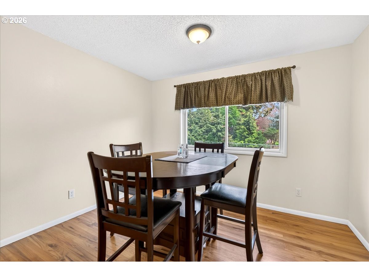 19650 Southwest Jaylee Street Beaverton, OR 97078 - Photo 19 of 46 a view of a dining room with furniture and wooden floor