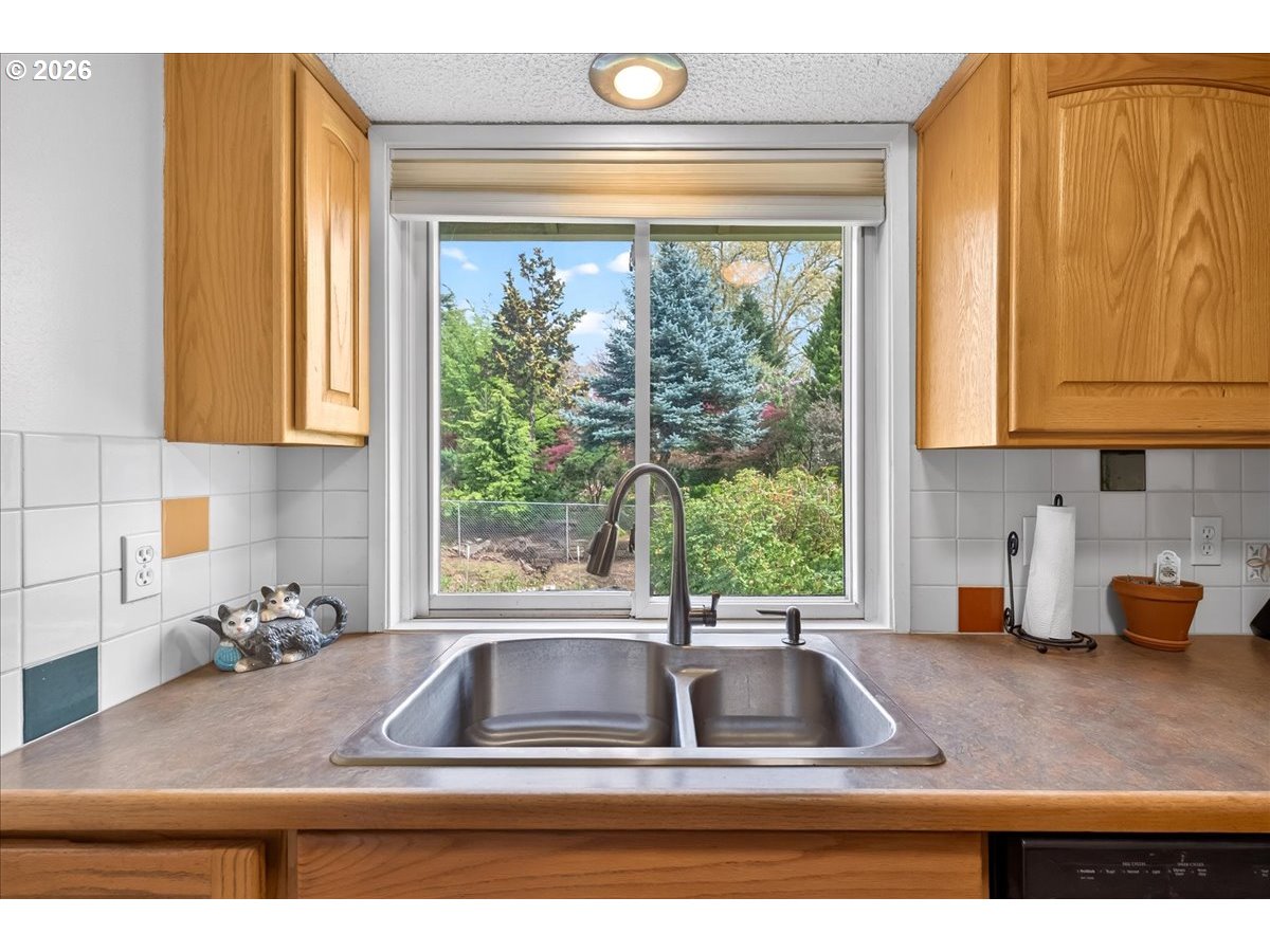 19650 Southwest Jaylee Street Beaverton, OR 97078 - Photo 21 of 46 a kitchen with granite countertop a sink and a window