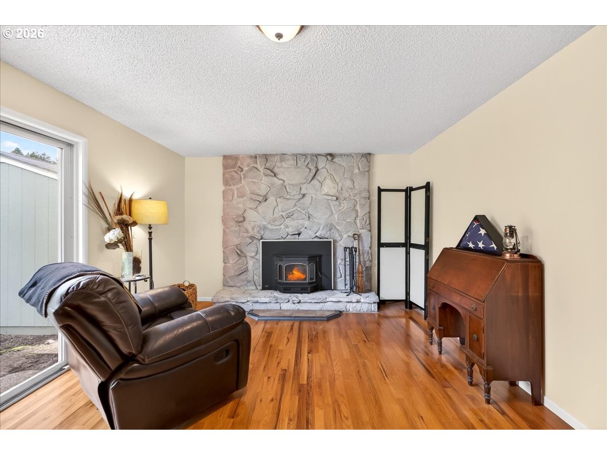 19650 Southwest Jaylee Street Beaverton, OR 97078 - Photo 25 of 46 a living room with furniture and a fireplace