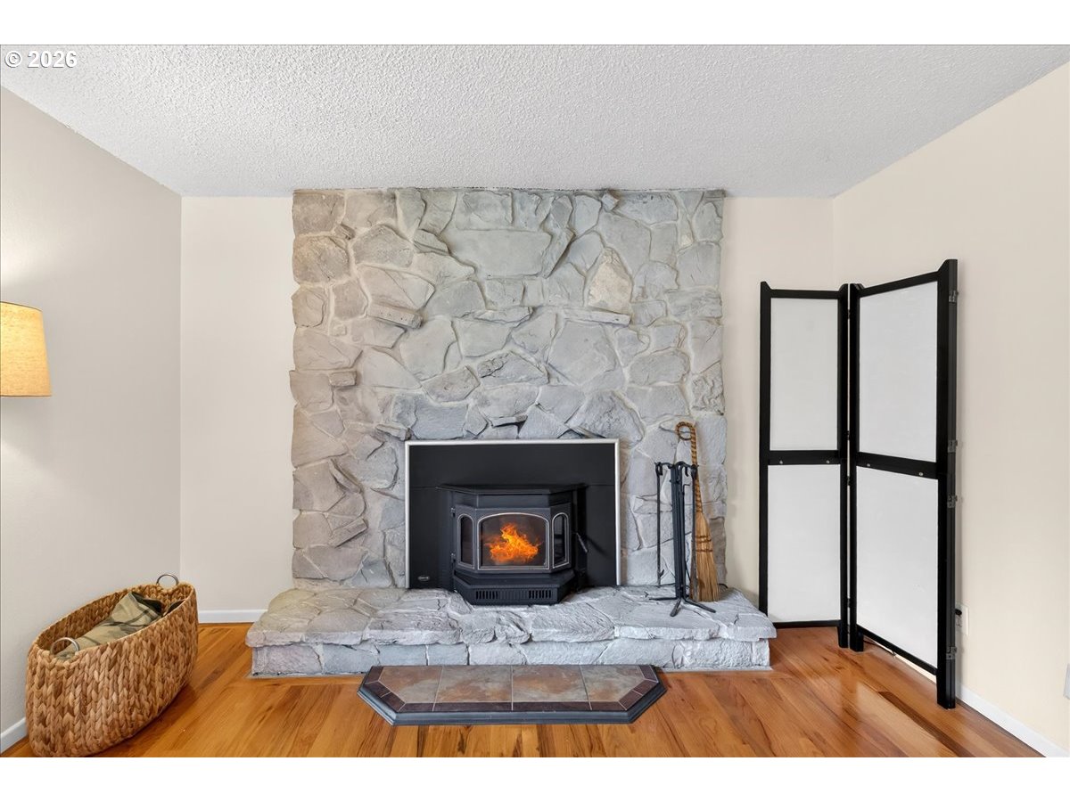 19650 Southwest Jaylee Street Beaverton, OR 97078 - Photo 27 of 46 a living room with furniture a fireplace and a wooden floor