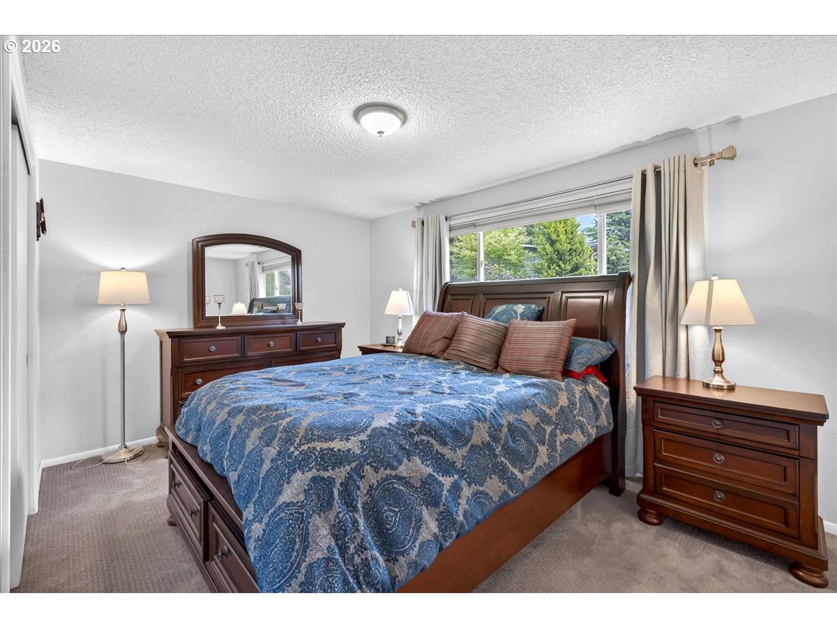 19650 Southwest Jaylee Street Beaverton, OR 97078 - Photo 29 of 46 a bedroom with a bed a window and dresser