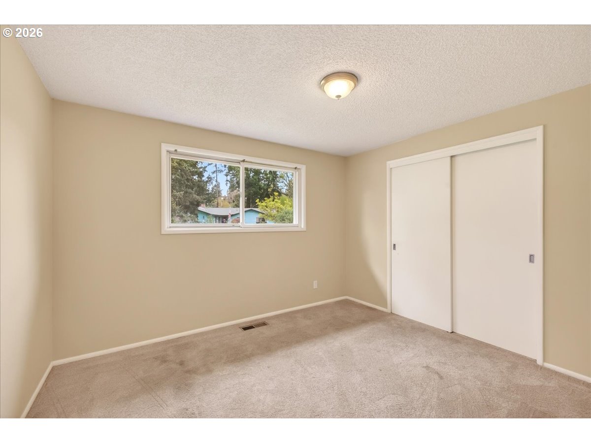 19650 Southwest Jaylee Street Beaverton, OR 97078 - Photo 32 of 46 a view of an empty room with a window