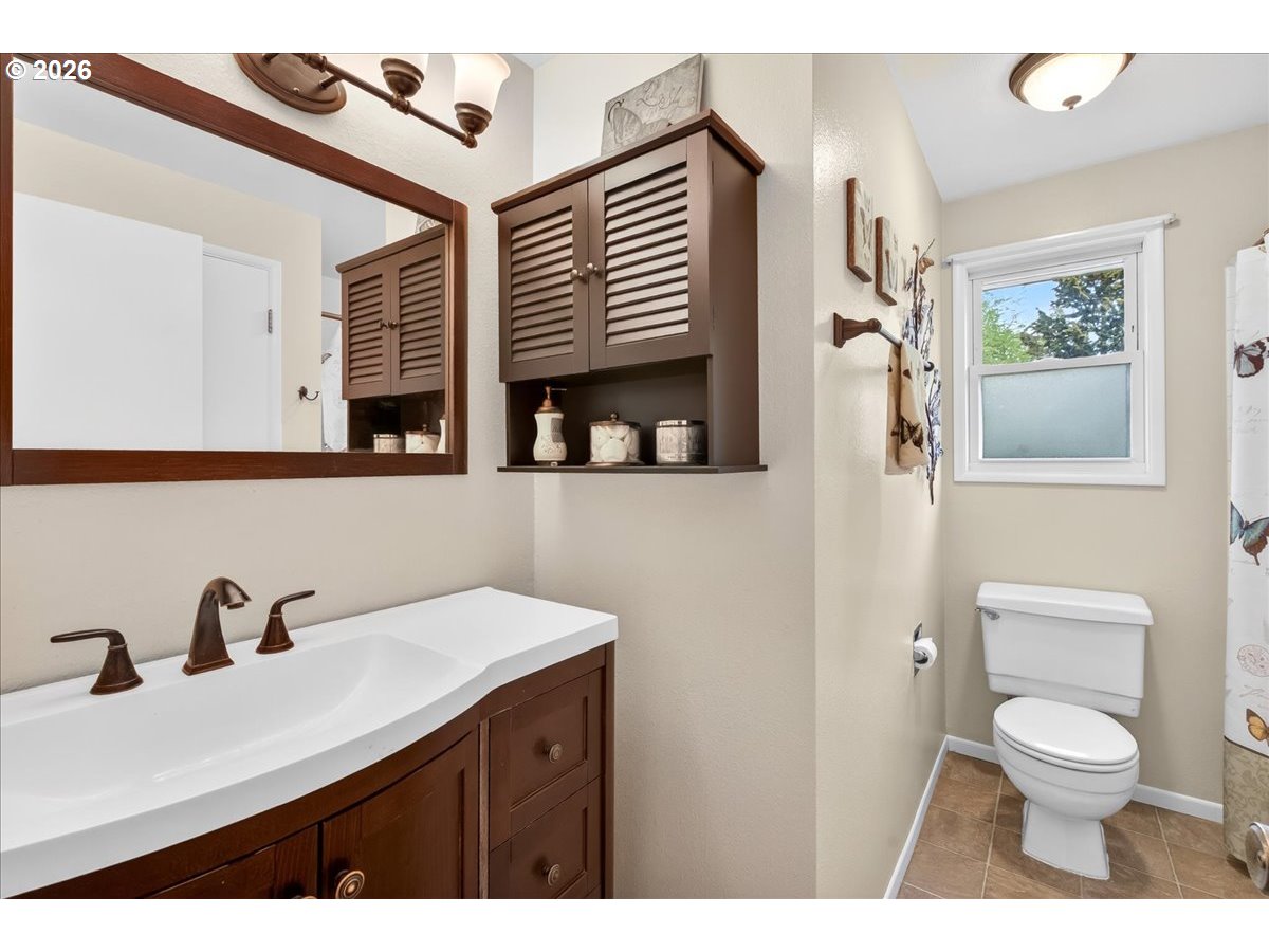 19650 Southwest Jaylee Street Beaverton, OR 97078 - Photo 35 of 46 a bathroom with a toilet a sink and mirror