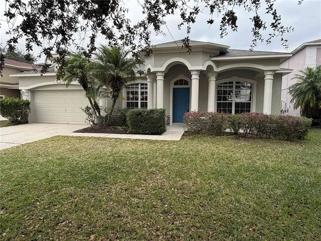 a view of a brick house with a yard
