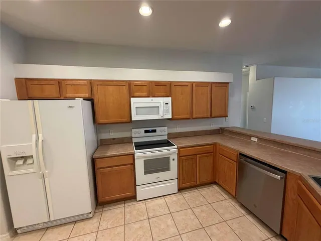 a kitchen with a stove a sink and a refrigerator