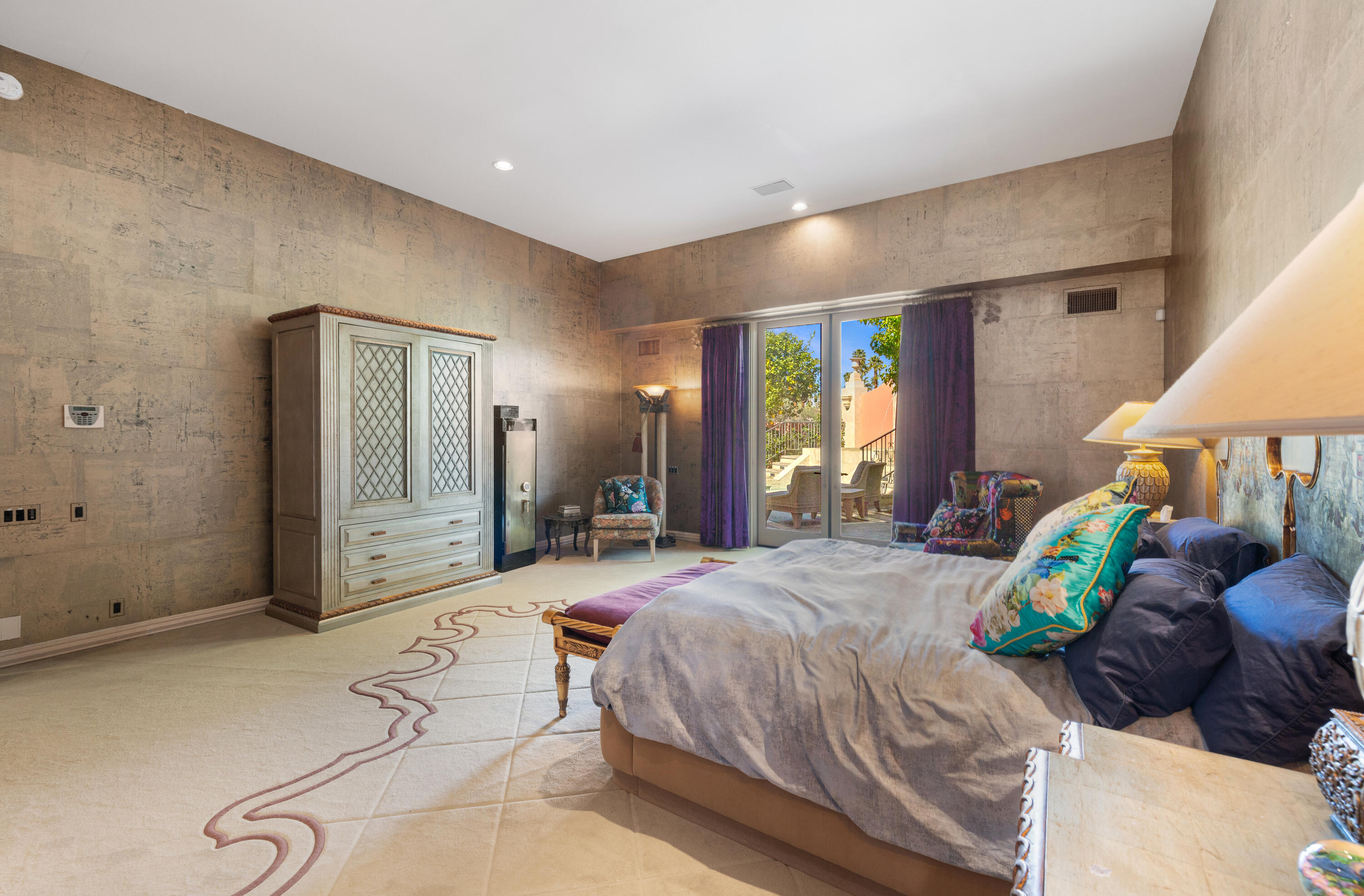 18 Vía Condotti Rancho Mirage, CA 92270 - Photo 11 of 79 a large bedroom with a bed and a chandelier