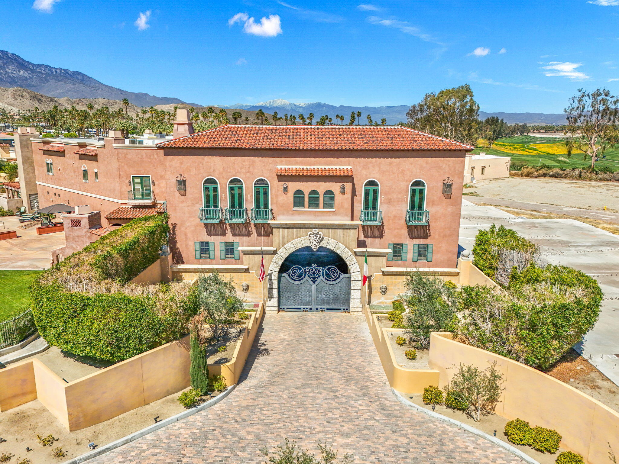18 Vía Condotti Rancho Mirage, CA 92270 - Photo 15 of 69 a view of a brick house with a swimming pool and a chairs