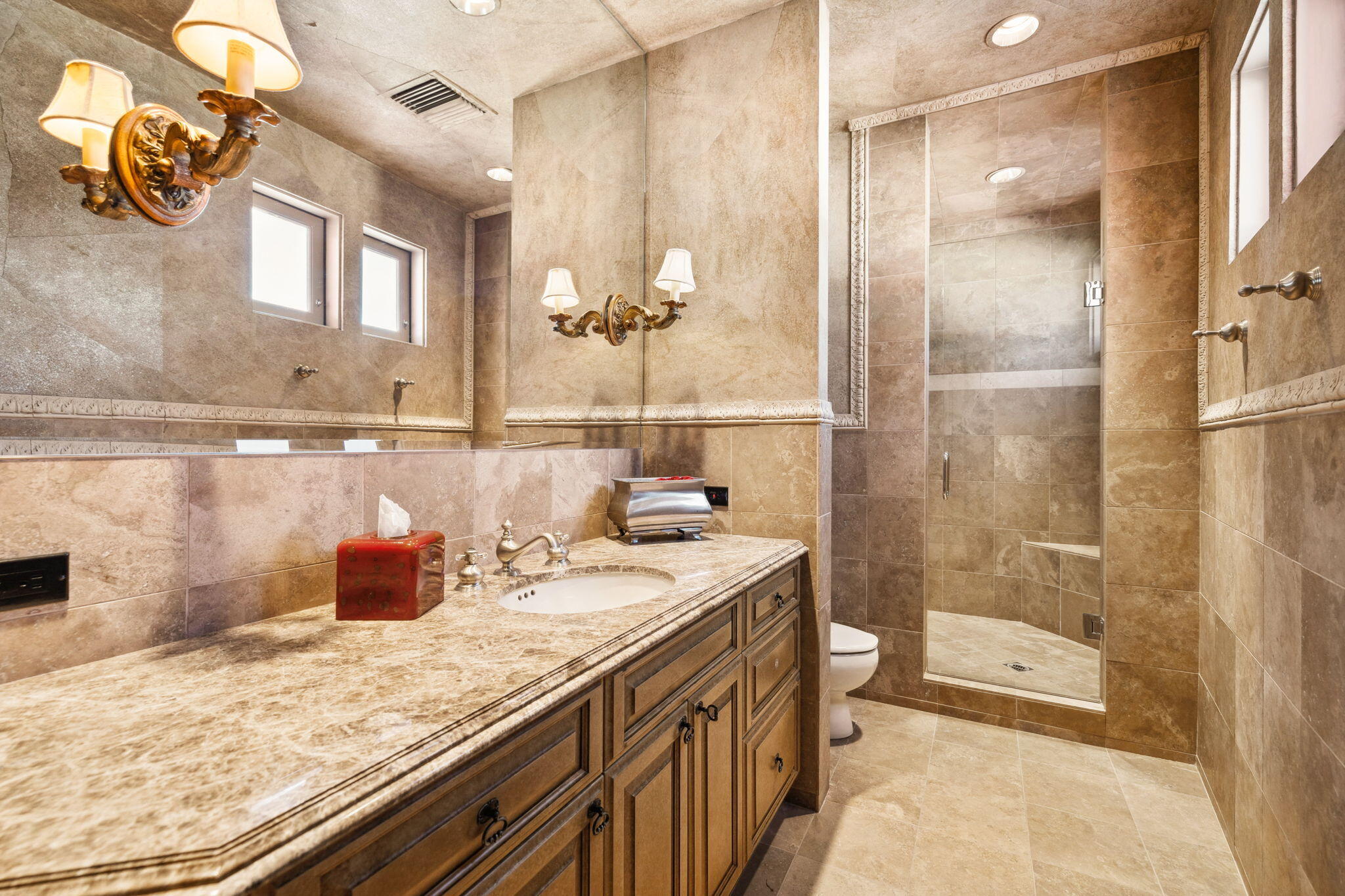 18 Vía Condotti Rancho Mirage, CA 92270 - Photo 17 of 69 a bathroom with a granite countertop sink a toilet a mirror and shower