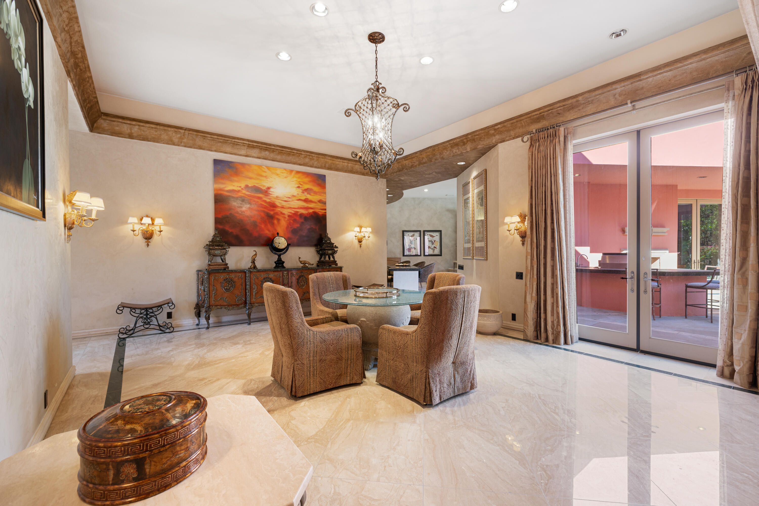 18 Vía Condotti Rancho Mirage, CA 92270 - Photo 21 of 79 a living room with furniture a chandelier and a large window