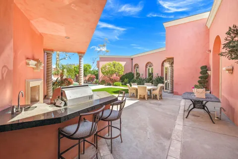 a spacious bathroom with a granite countertop double vanity and a large mirror