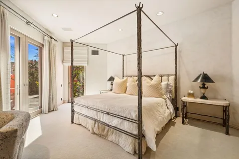 a bedroom with a bed and a couch