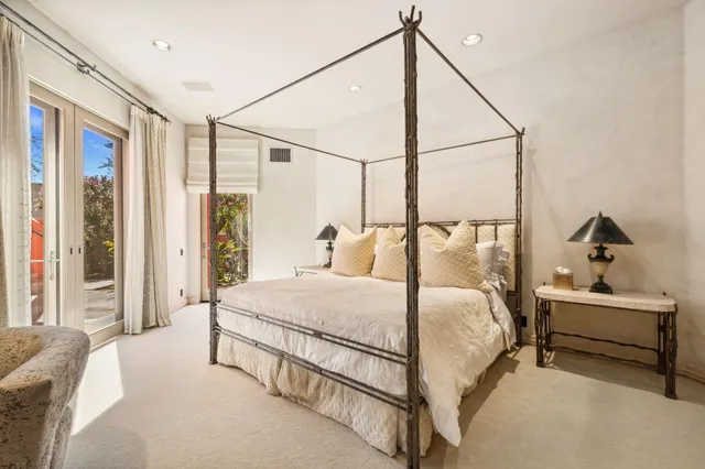 a bedroom with a bed and a couch