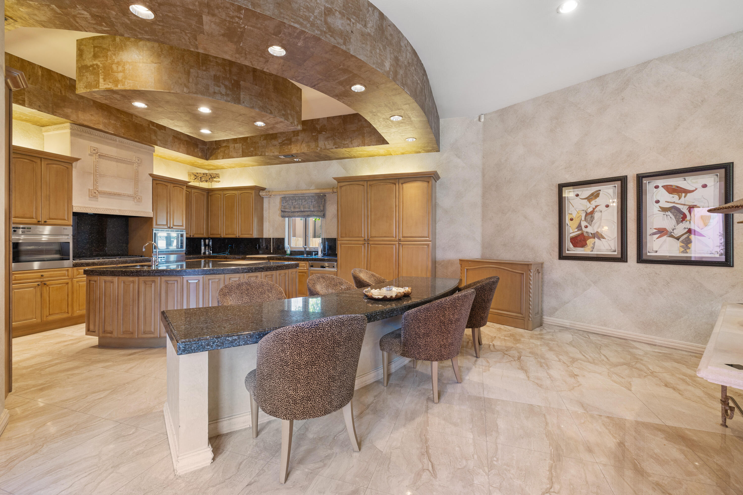 18 Vía Condotti Rancho Mirage, CA 92270 - Photo 26 of 79 a kitchen with stainless steel appliances kitchen island granite countertop a sink and a refrigerator