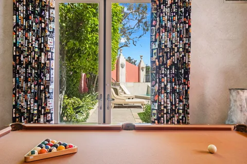a view of a patio with couches table and chairs and potted plants
