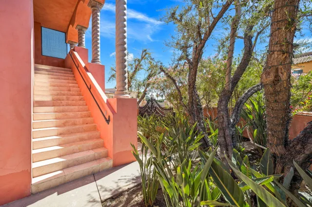 a dining room with furniture and a floor to ceiling window