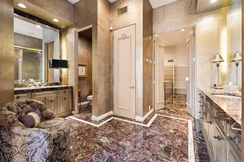 a bed room with a bed and a chair