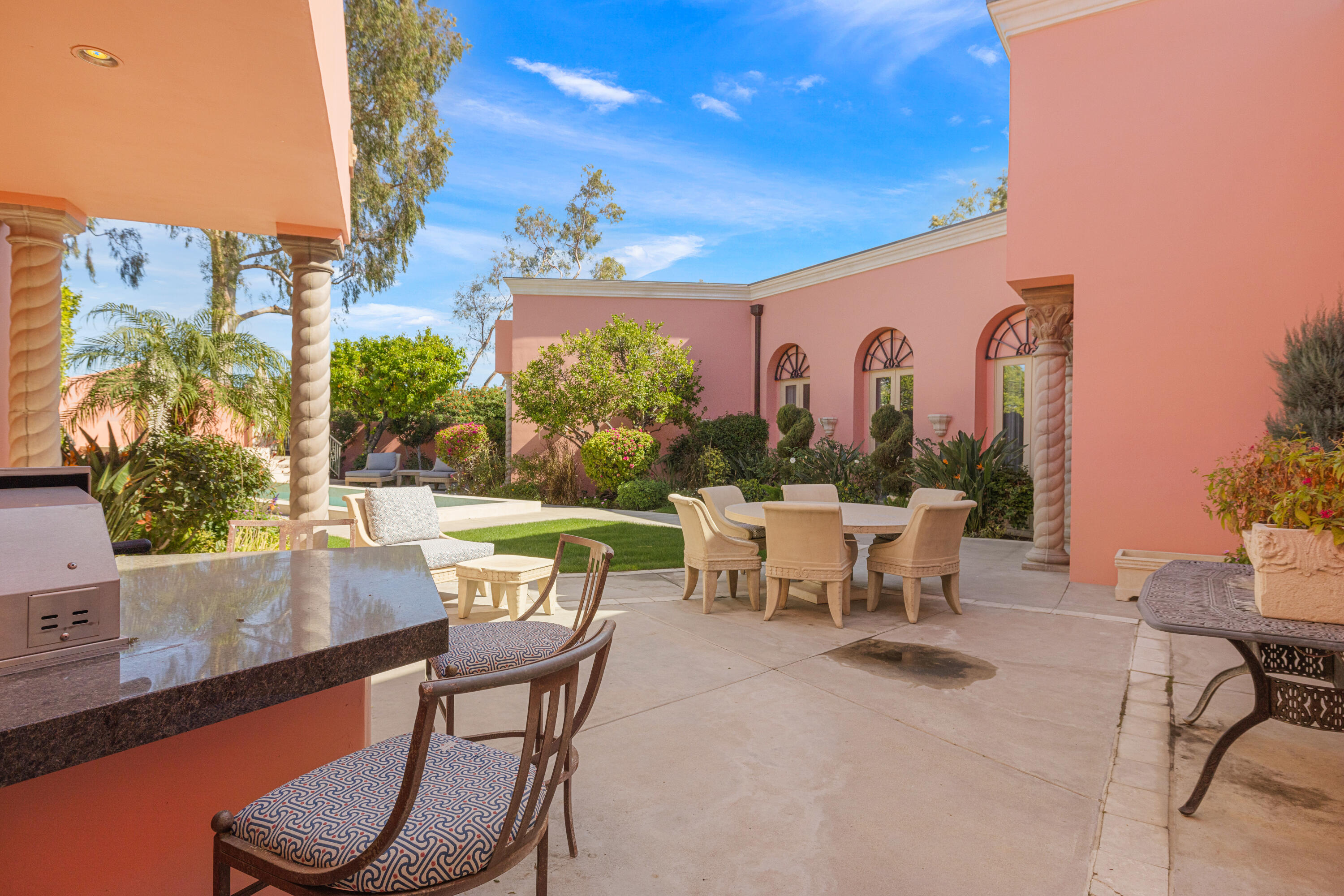 18 Vía Condotti Rancho Mirage, CA 92270 - Photo 57 of 79 a view of a patio with table and chairs and potted plants