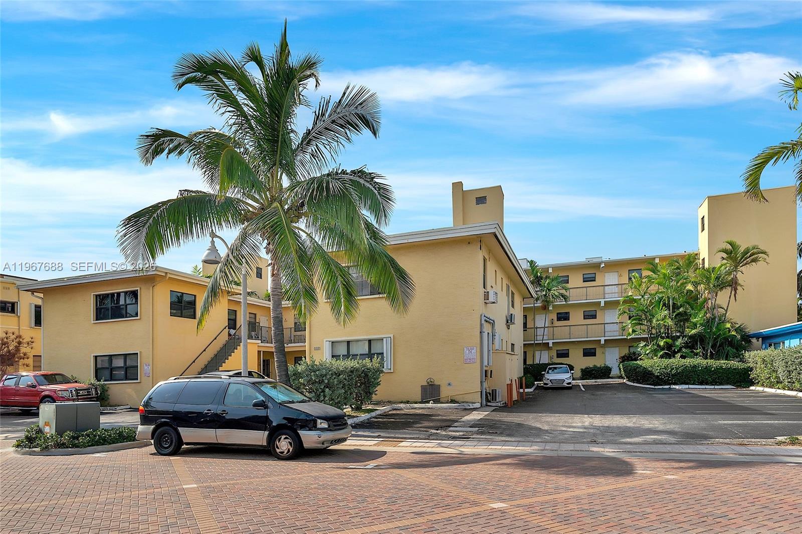 322 Harding Street, Unit B202 Hollywood, FL 33019 - Photo 15 of 39 a car parked in front of a house with a yard