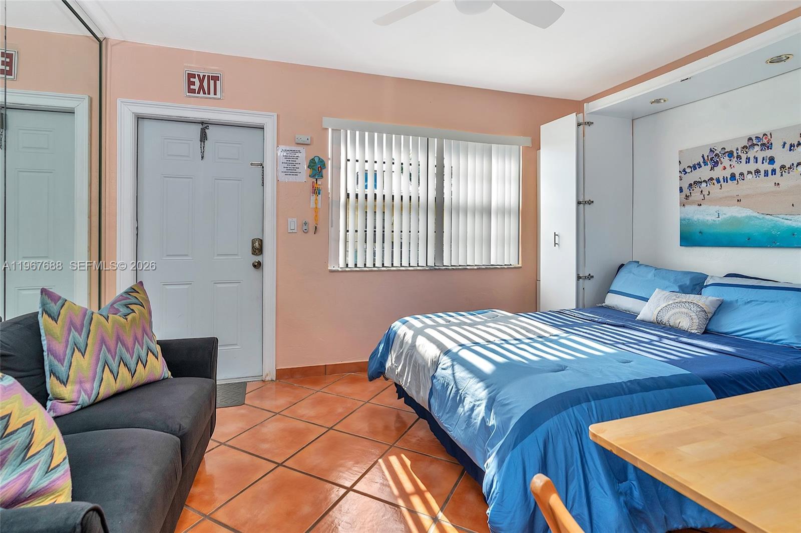322 Harding Street, Unit B202 Hollywood, FL 33019 - Photo 22 of 39 a bedroom with a bed and wooden floor