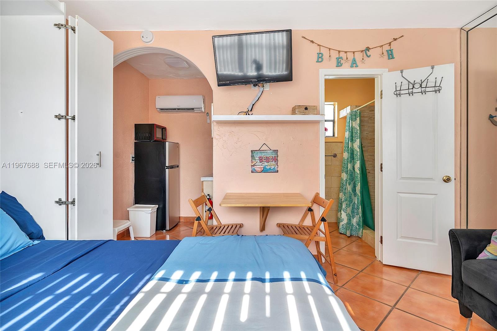 322 Harding Street, Unit B202 Hollywood, FL 33019 - Photo 30 of 39 a bedroom with a bed and wooden floor