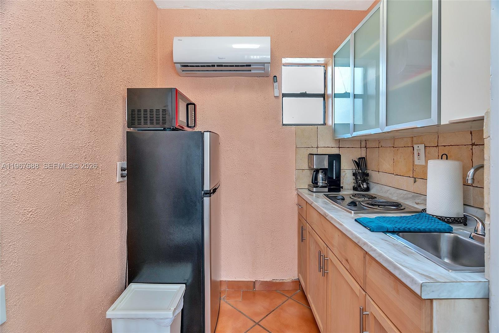 322 Harding Street, Unit B202 Hollywood, FL 33019 - Photo 33 of 39 a kitchen with stainless steel appliances granite countertop a refrigerator and a sink