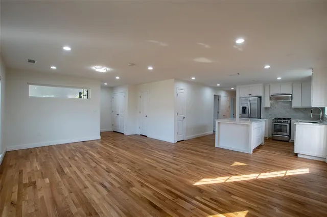 a view of kitchen with kitchen island sink and refrigerator