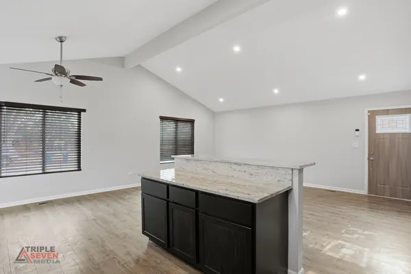 a view of kitchen with a sink cabinet and window