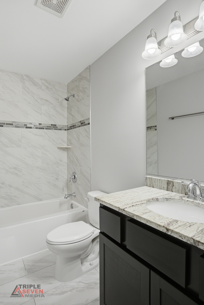 14528 Kolin Avenue Midlothian, IL 60445 - Photo 18 of 29 a bathroom with a granite countertop sink a toilet and shower