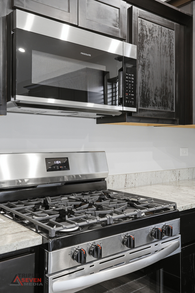 14528 Kolin Avenue Midlothian, IL 60445 - Photo 10 of 29 a stove sitting inside of a kitchen with granite countertop