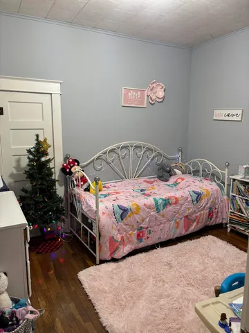 a bedroom with a bed and a dresser