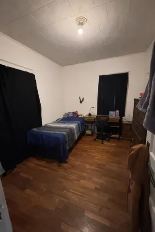 a bedroom with a bed and a chair