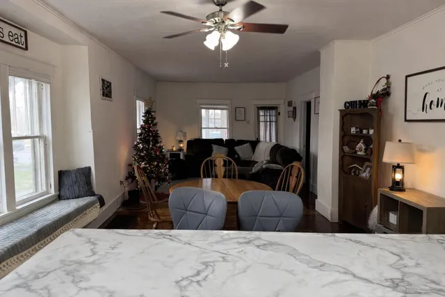 a living room with furniture a chandelier and a window