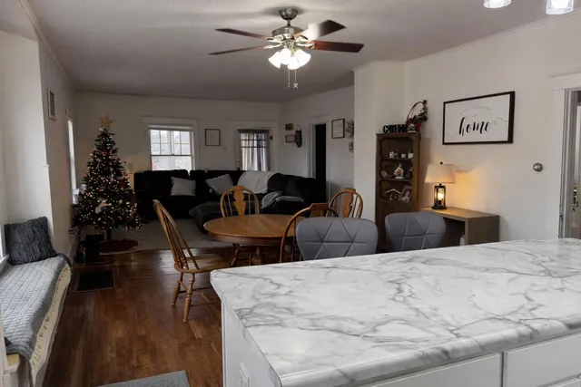 a living room with furniture a chandelier and a window