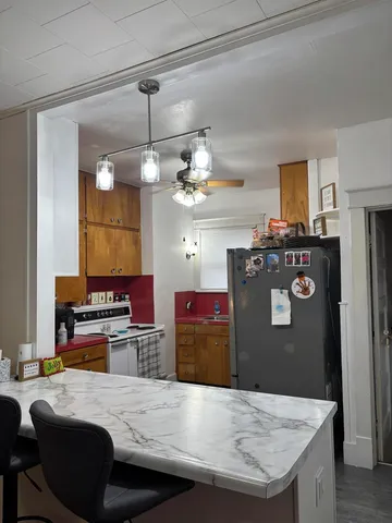 a kitchen with stainless steel appliances granite countertop a stove oven and a refrigerator