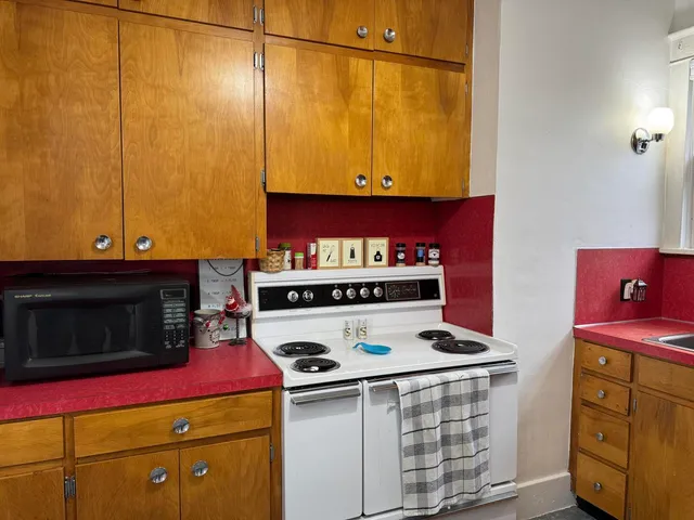 a kitchen with stainless steel appliances granite countertop a stove and a microwave