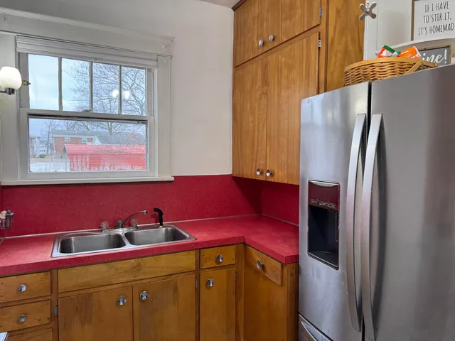a kitchen with stainless steel appliances a refrigerator a stove and a window