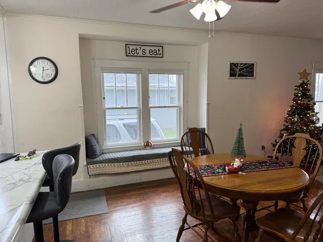 a view of a dining room with furniture and wooden floor