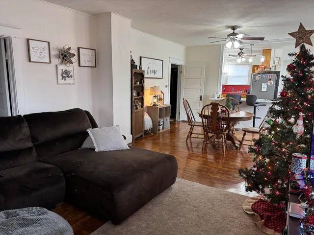 a living room with furniture and a mirror