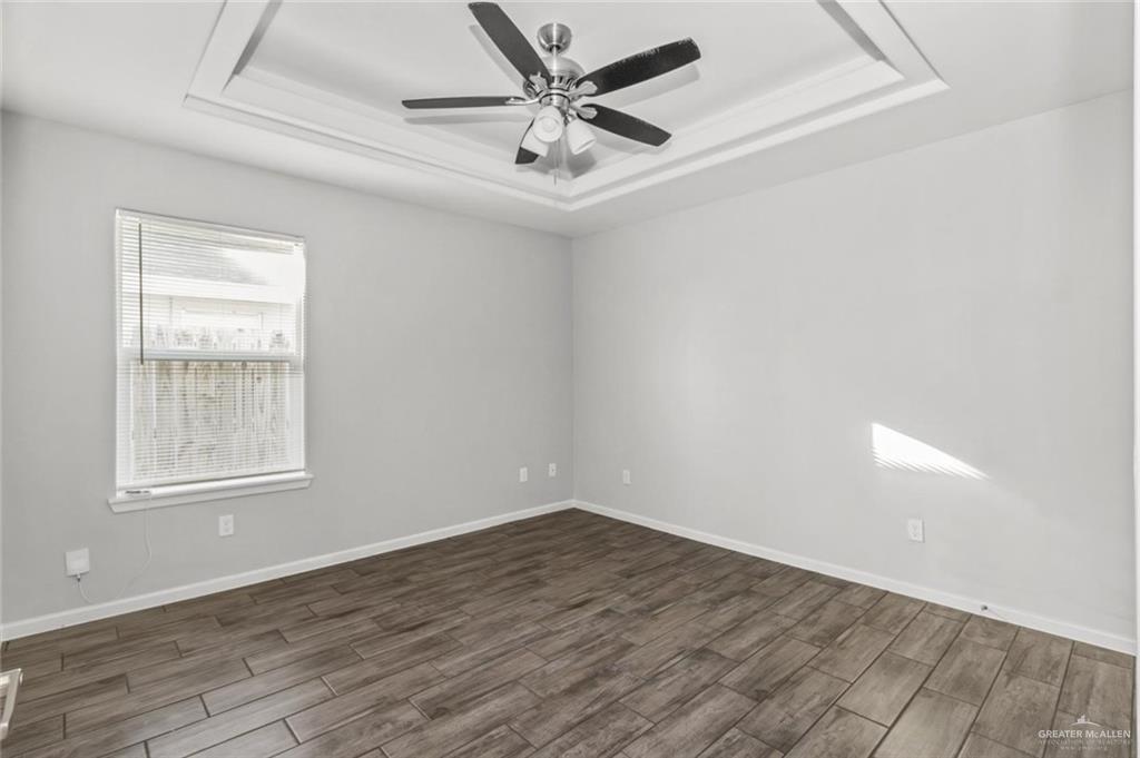 2011 Stardust Lane, Unit 4 Edinburg, TX 78541 - Photo 5 of 10 an empty room with wooden floor and windows
