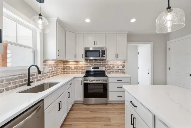 a kitchen with cabinets a sink and stainless steel appliances