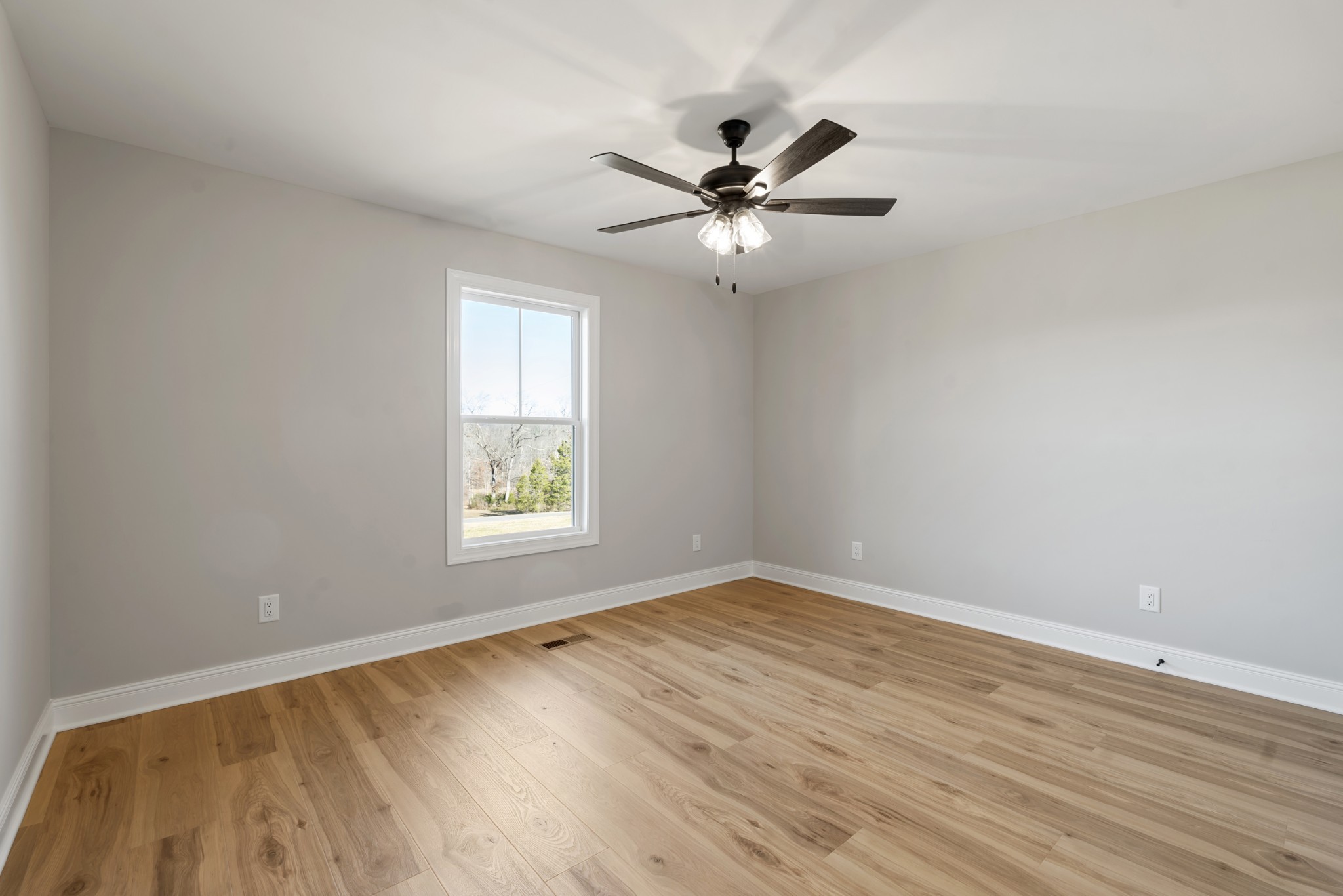 8184 Gideon Road Greenbrier, TN 37073 - Photo 14 of 25 a view of an empty room with wooden floor and a window