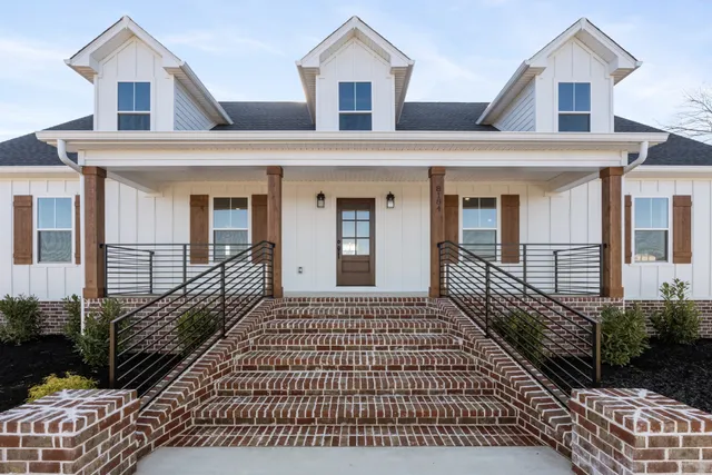 a front view of a house with a garden