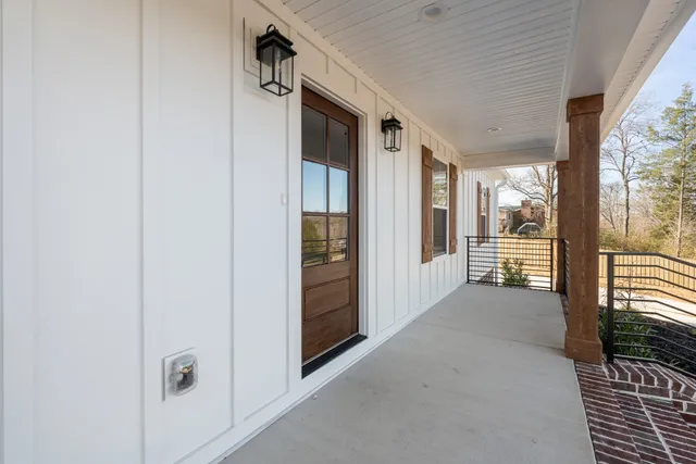 a view of a hallway with wooden floor and windows