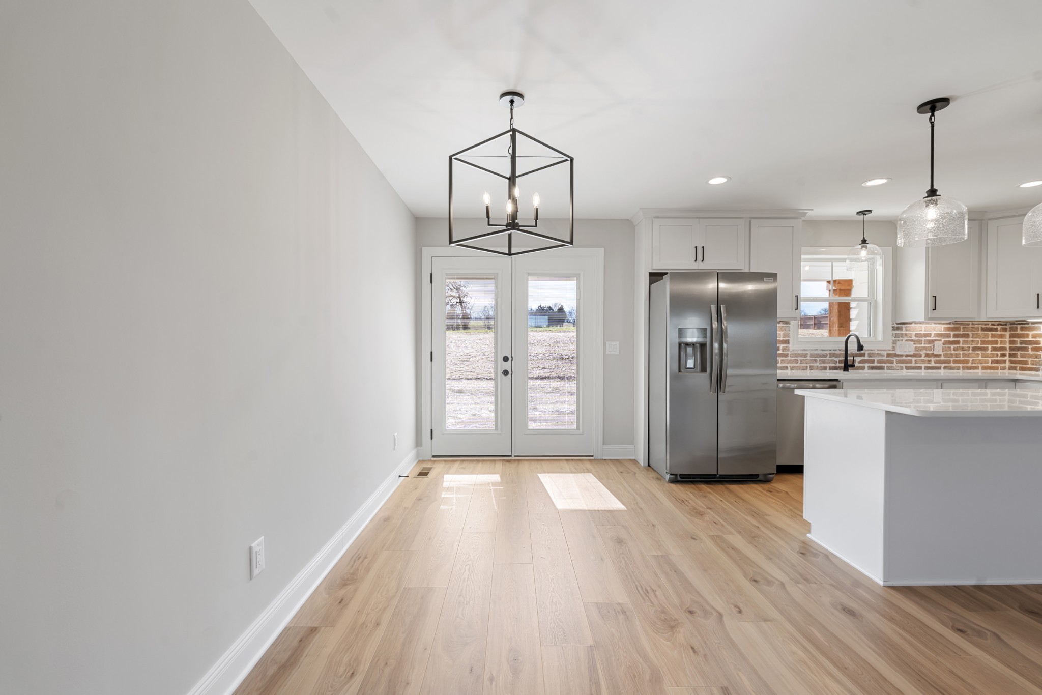8184 Gideon Road Greenbrier, TN 37073 - Photo 8 of 25 a kitchen with stainless steel appliances granite countertop a refrigerator oven a sink dishwasher and white cabinets with wooden floor